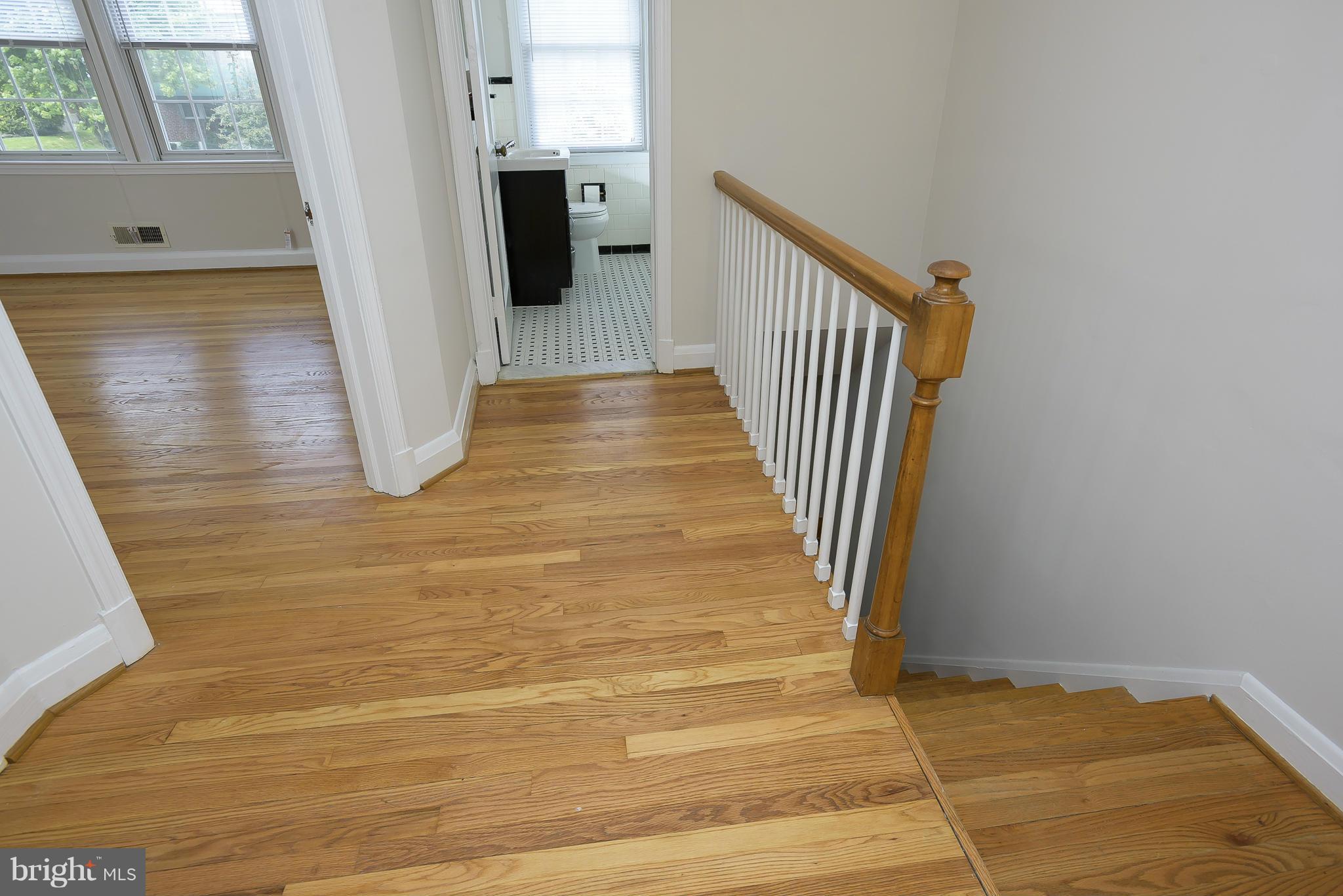 6125 Regent Park Road Catonsville, MD 21228 - Photo 13 of 25 a view of a hallway with wooden floor and staircase