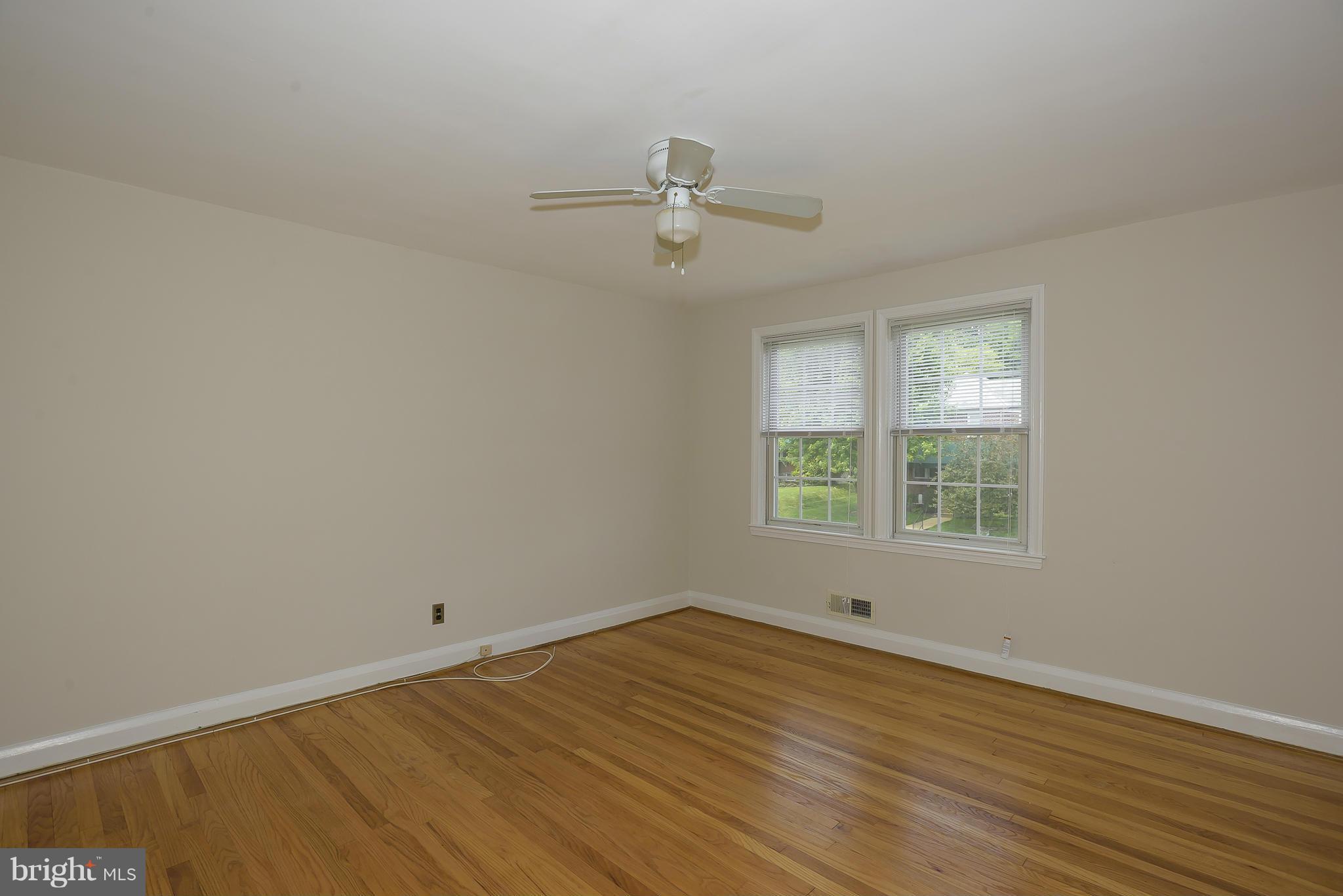 6125 Regent Park Road Catonsville, MD 21228 - Photo 14 of 25 an empty room with wooden floor and windows