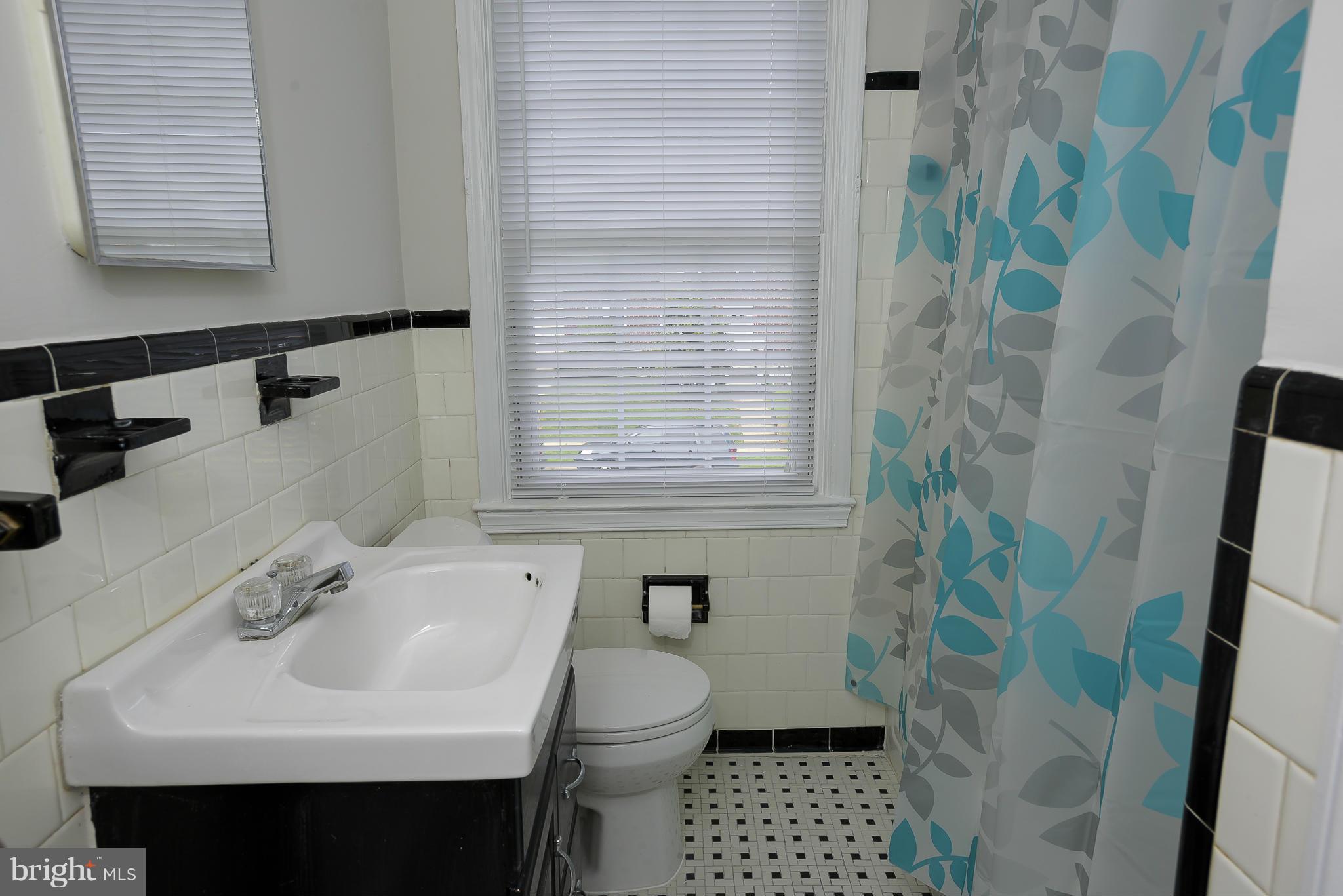 6125 Regent Park Road Catonsville, MD 21228 - Photo 15 of 25 a bathroom with a sink toilet and shower