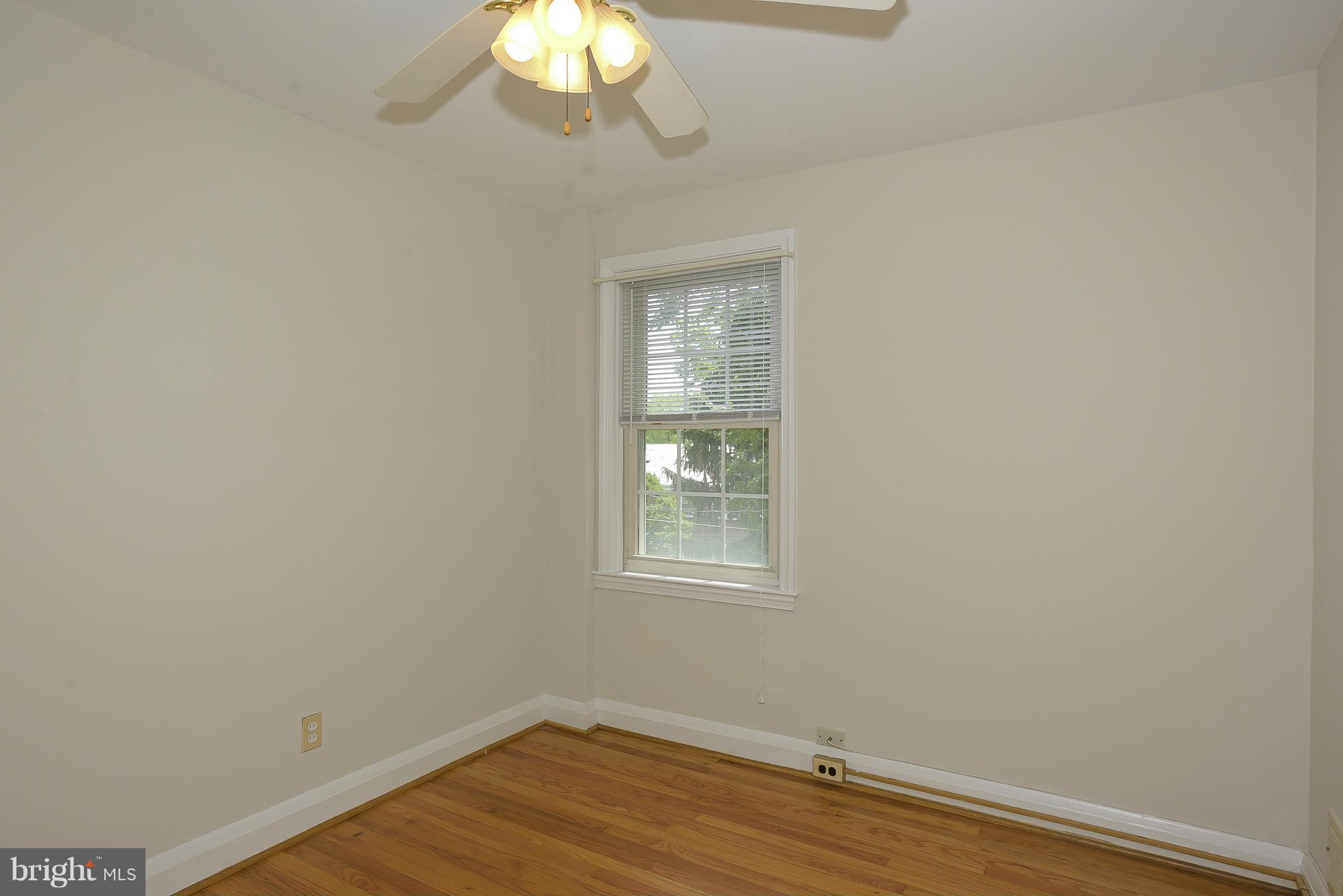 6125 Regent Park Road Catonsville, MD 21228 - Photo 16 of 25 an empty room with wooden floor and windows