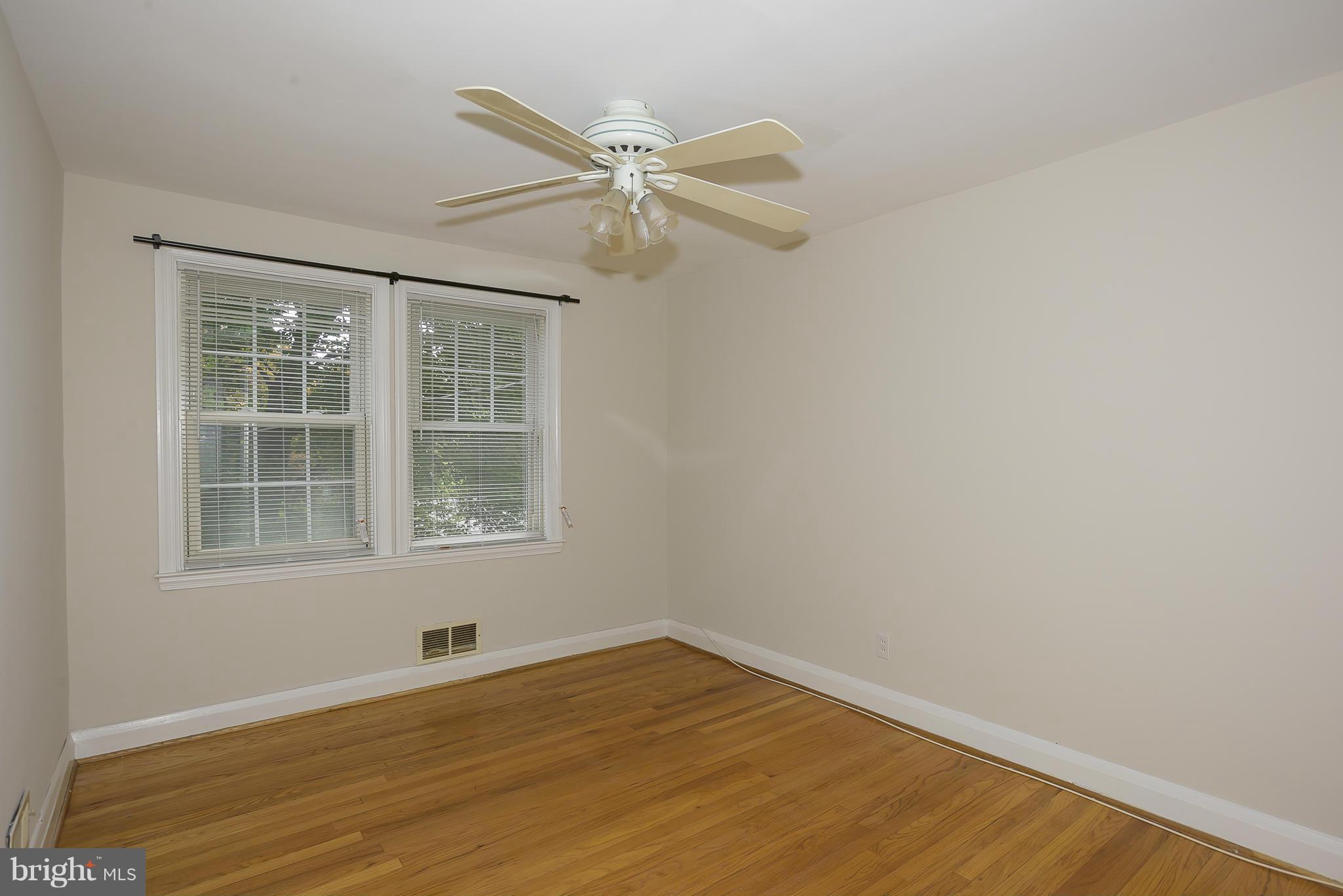6125 Regent Park Road Catonsville, MD 21228 - Photo 17 of 25 an empty room with wooden floor fan and windows