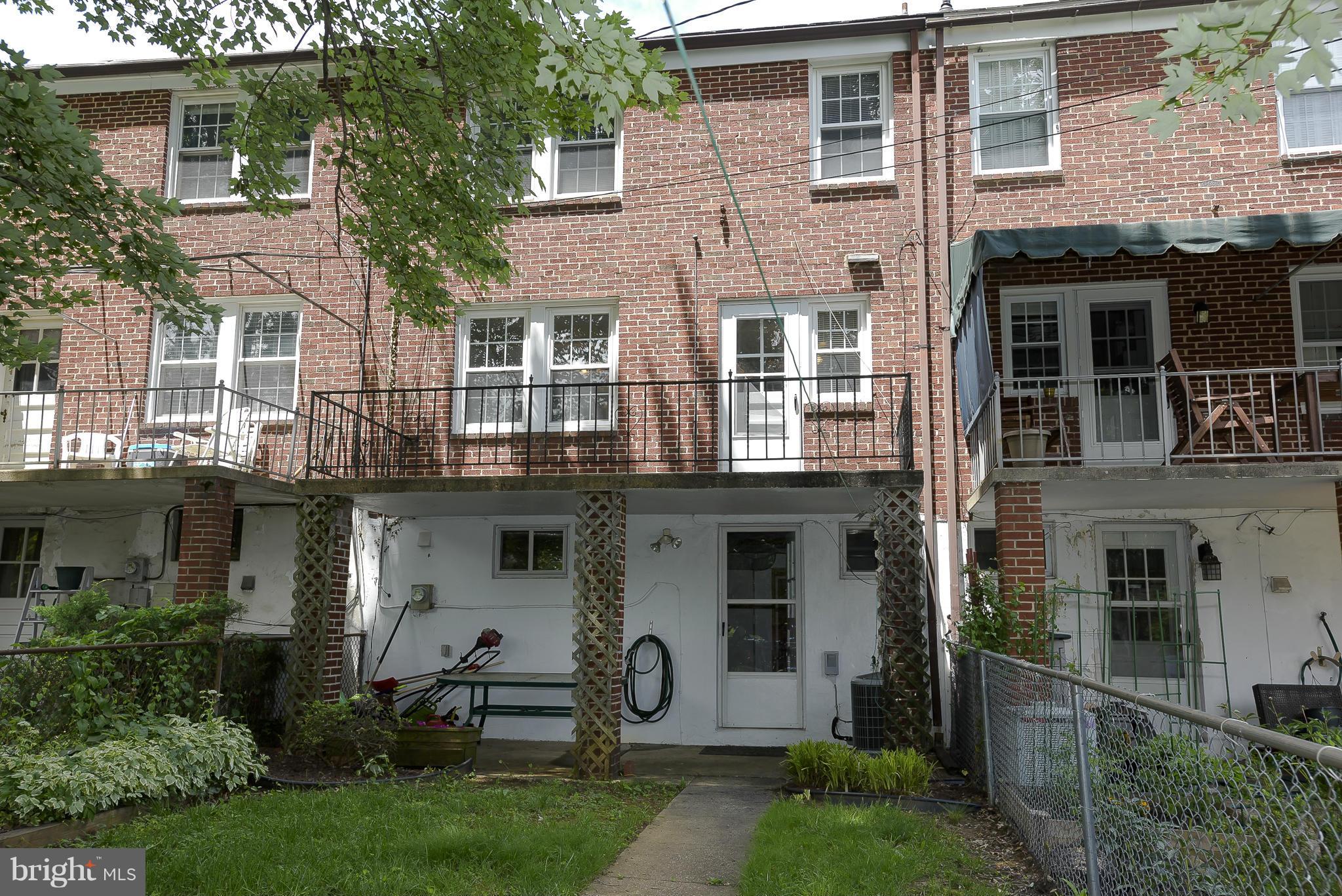 6125 Regent Park Road Catonsville, MD 21228 - Photo 24 of 25 front view of a brick house with a yard and a large tree