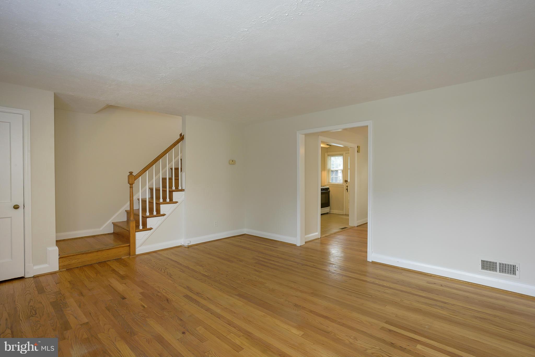 6125 Regent Park Road Catonsville, MD 21228 - Photo 4 of 25 a view of an empty room with wooden floor and a window