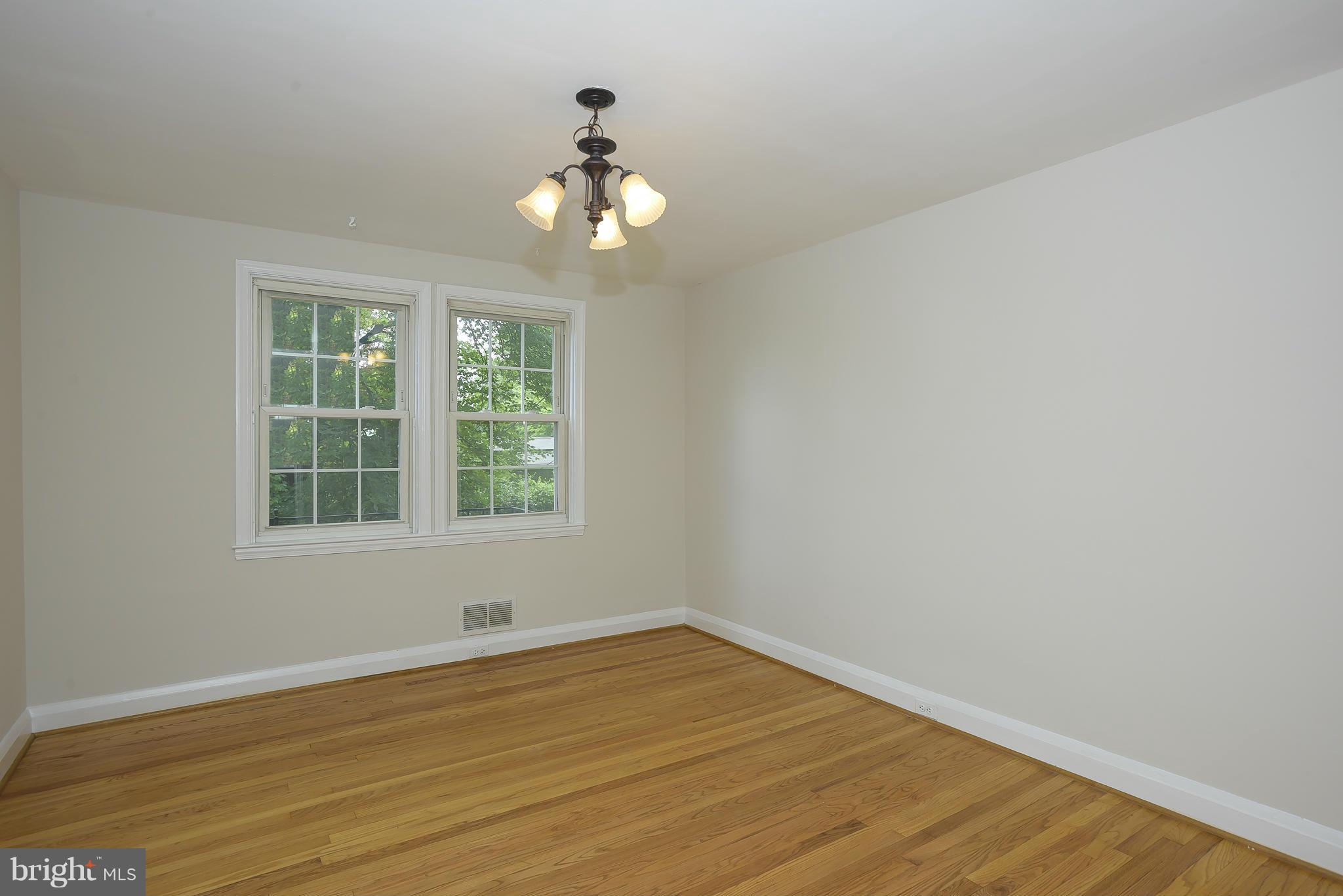 6125 Regent Park Road Catonsville, MD 21228 - Photo 6 of 25 a view of an empty room with wooden floor and a window