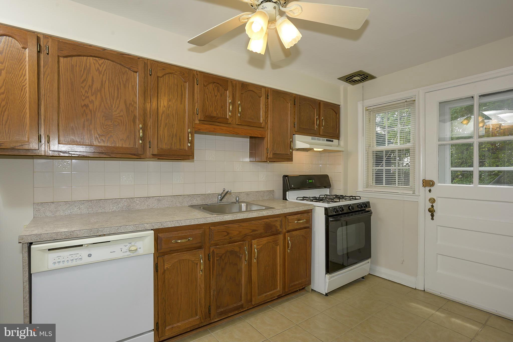 6125 Regent Park Road Catonsville, MD 21228 - Photo 10 of 25 a kitchen with a sink stove and cabinets