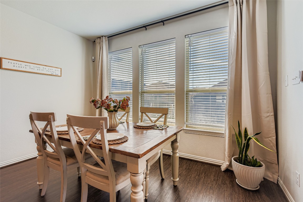 1075 Cherrystone Loop Buda, TX 78610 - Photo 12 of 28 a view of a dining room with furniture and wooden floor