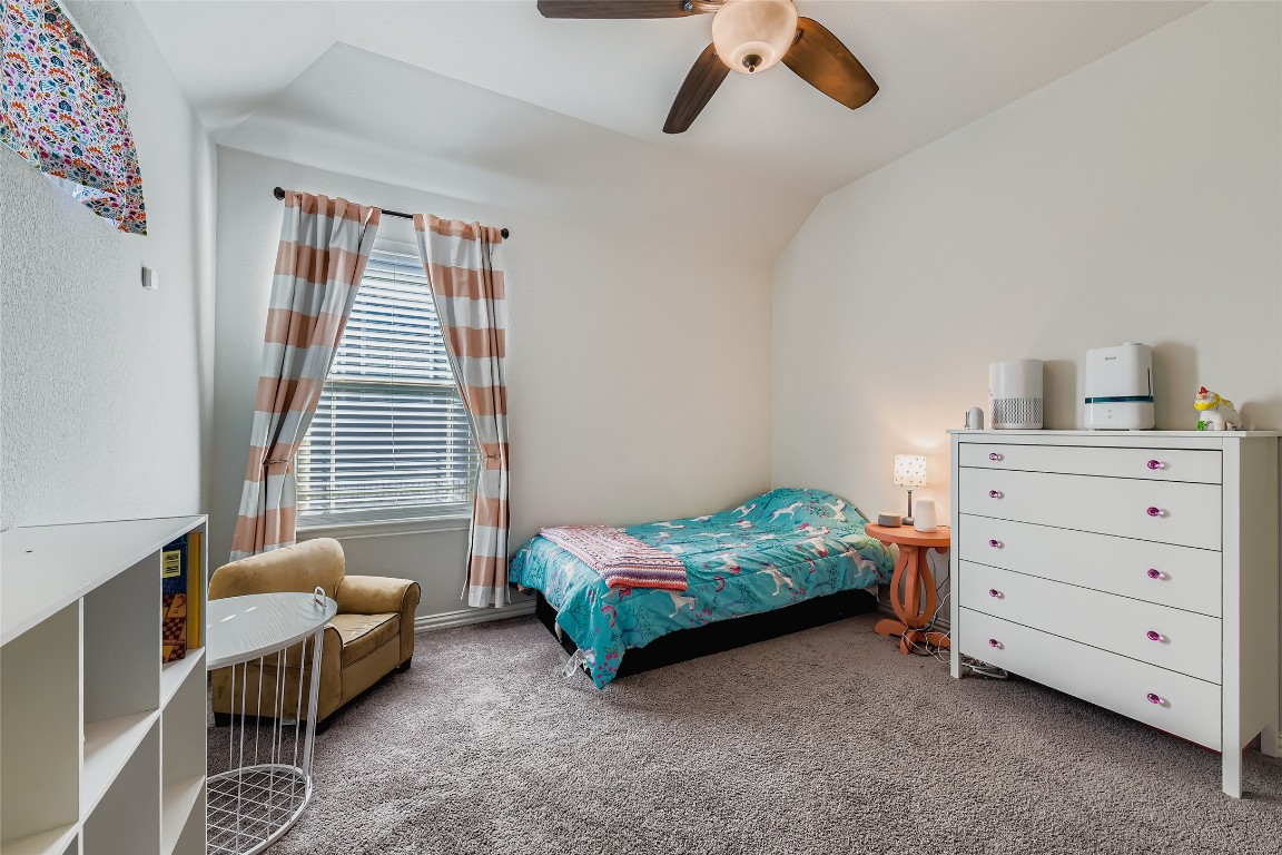 1075 Cherrystone Loop Buda, TX 78610 - Photo 19 of 28 a bedroom with furniture and a window