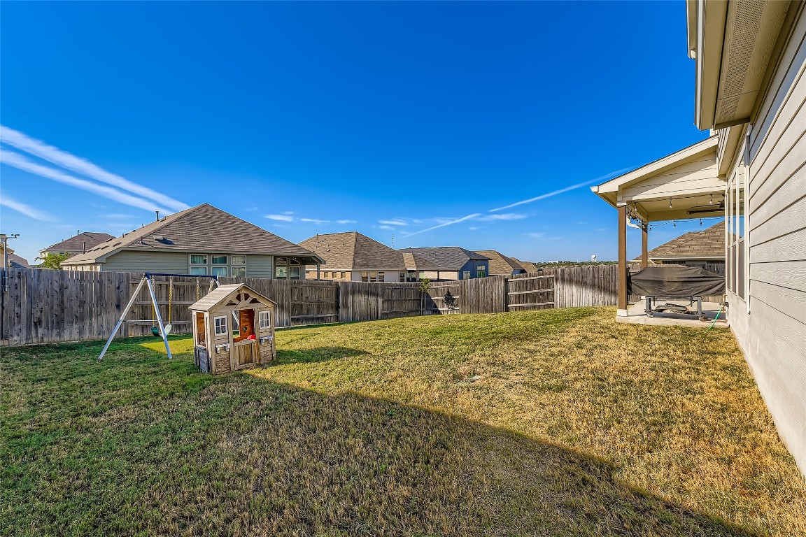 1075 Cherrystone Loop Buda, TX 78610 - Photo 26 of 28 a view of a house with backyard and porch