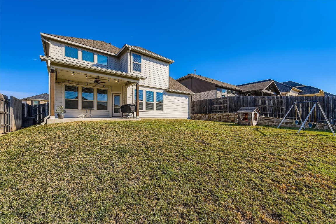 1075 Cherrystone Loop Buda, TX 78610 - Photo 27 of 28 a front view of a house with a yard