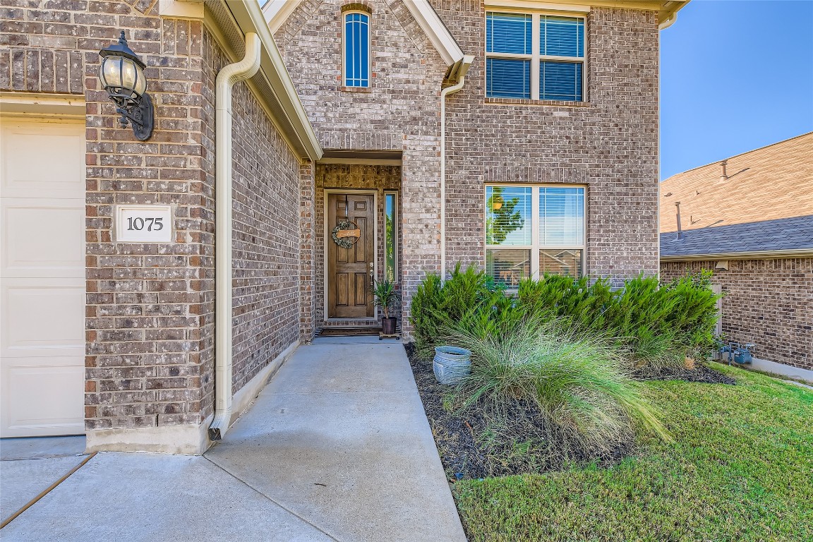 1075 Cherrystone Loop Buda, TX 78610 - Photo 3 of 28 a view of a brick house with a large windows