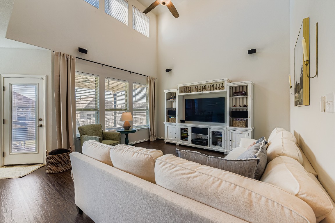 1075 Cherrystone Loop Buda, TX 78610 - Photo 8 of 28 a living room with furniture a flat screen tv and a large window
