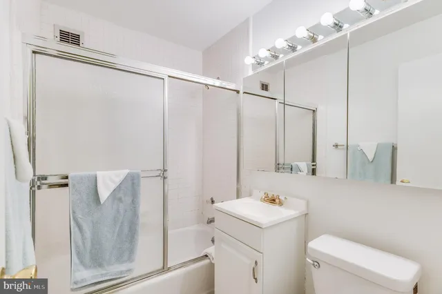 a bathroom with a shower a sink and a mirror