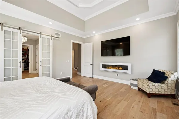 a spacious bathroom with a shower a sink and a mirror