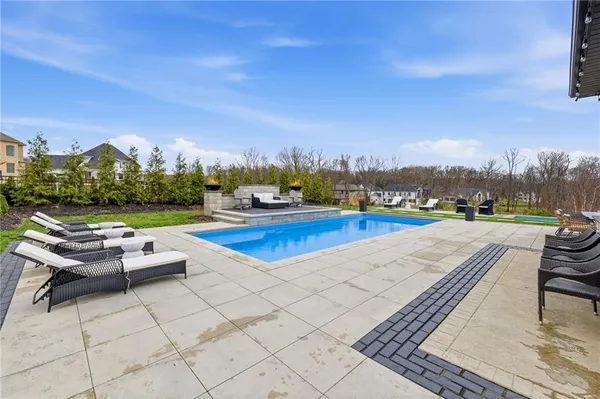 a view of a terrace with lawn chairs