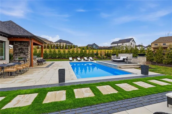 a view of a house with swimming pool yard and outdoor seating
