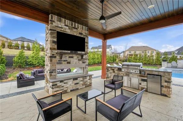 a view of a house with backyard sitting area and garden