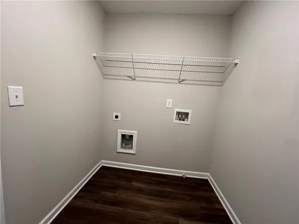 a view of storage and utility room with wooden floor