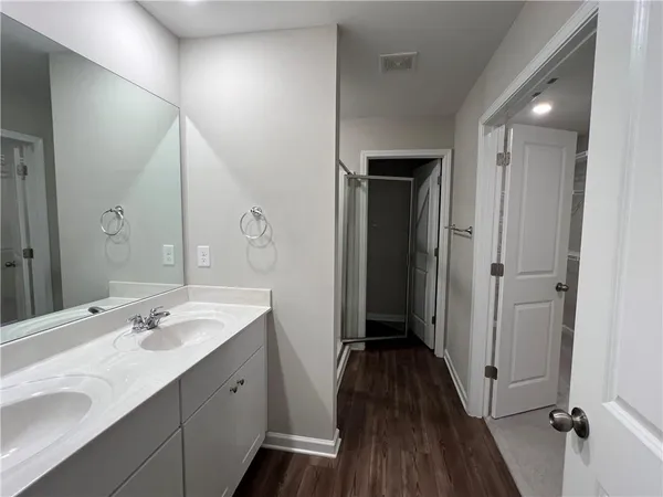 a bathroom with a double vanity sink and mirror