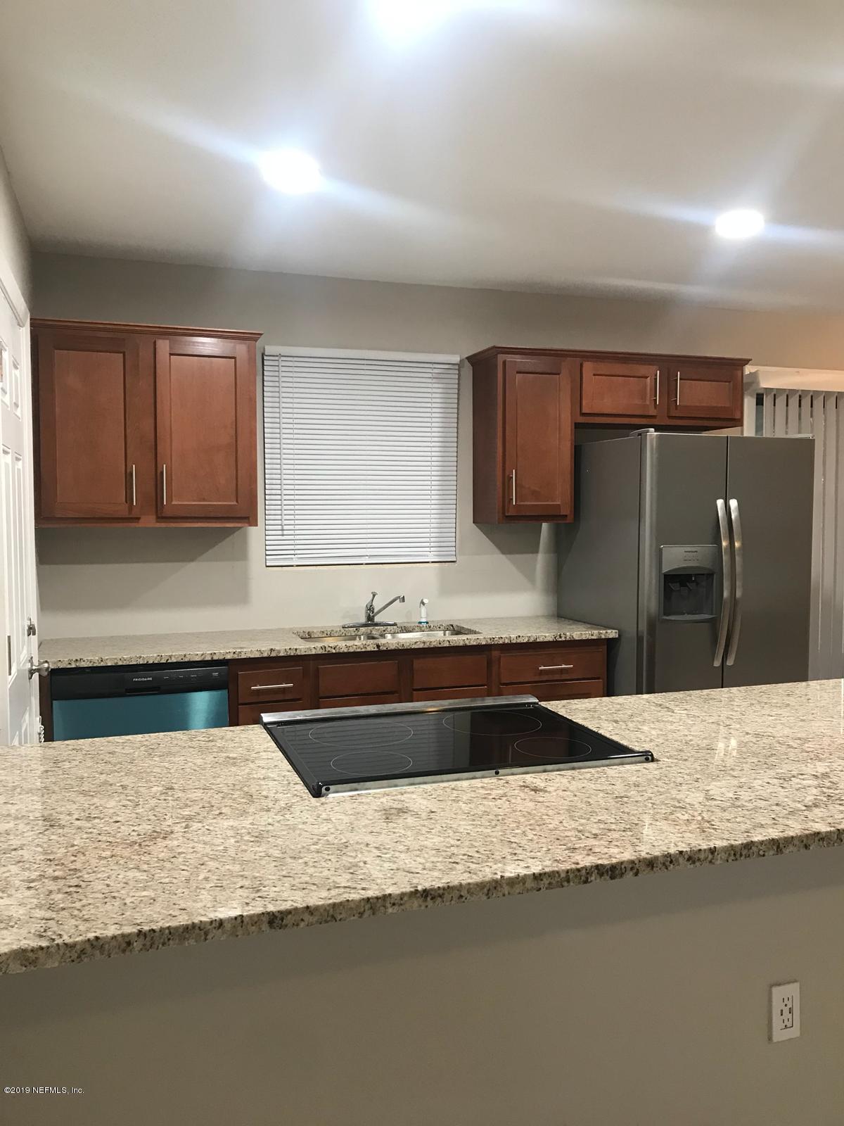 4705 Ruckner Road Jacksonville, FL 32207 - Photo 11 of 24 a kitchen with granite countertop a sink and a stove top oven