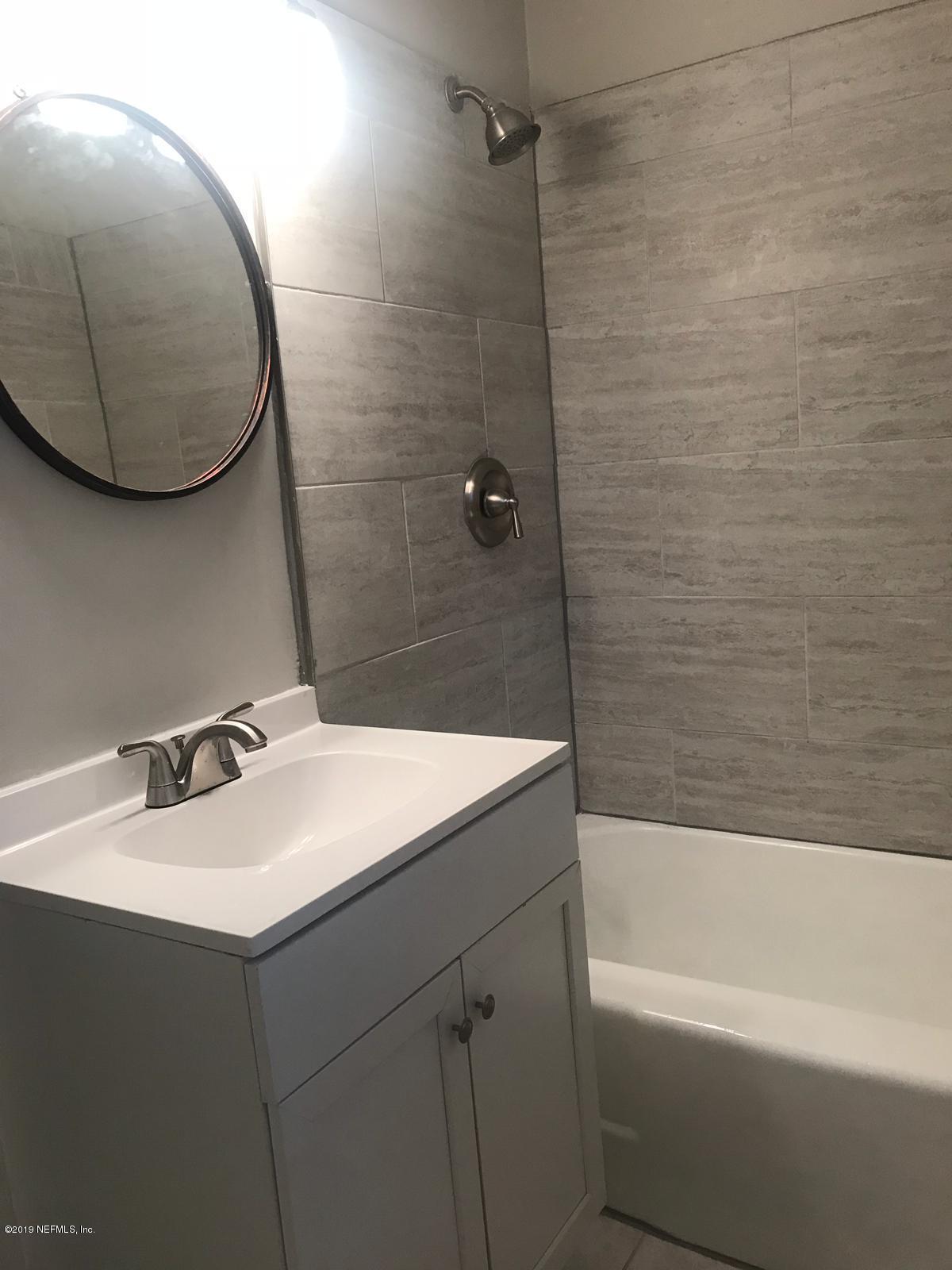 4705 Ruckner Road Jacksonville, FL 32207 - Photo 19 of 24 a bathroom with a sink vanity tub and a mirror