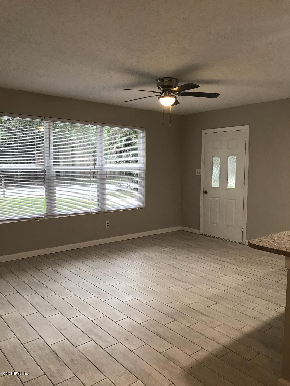 4705 Ruckner Road Jacksonville, FL 32207 - Photo 5 of 24 an empty room with wooden floor and windows