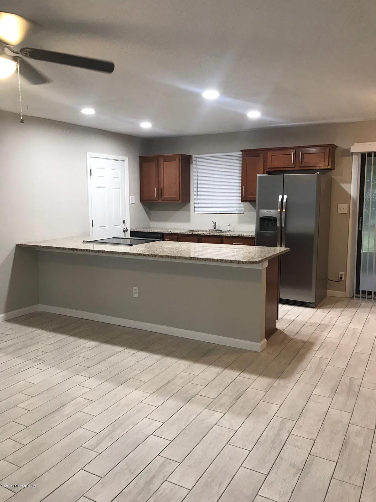 4705 Ruckner Road Jacksonville, FL 32207 - Photo 6 of 24 a kitchen with stainless steel appliances granite countertop a sink and a refrigerator