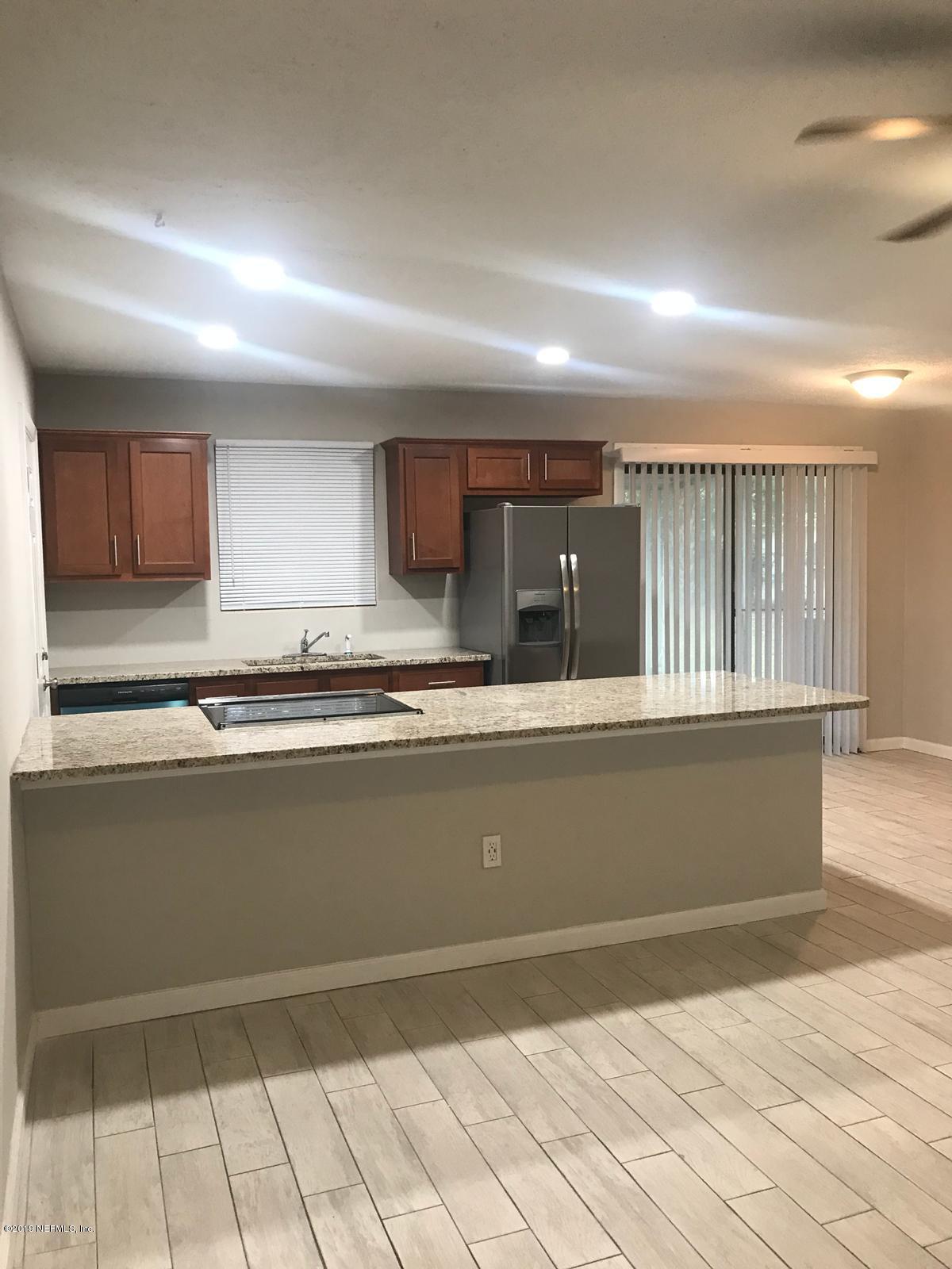 4705 Ruckner Road Jacksonville, FL 32207 - Photo 9 of 24 a kitchen with granite countertop a sink and cabinets