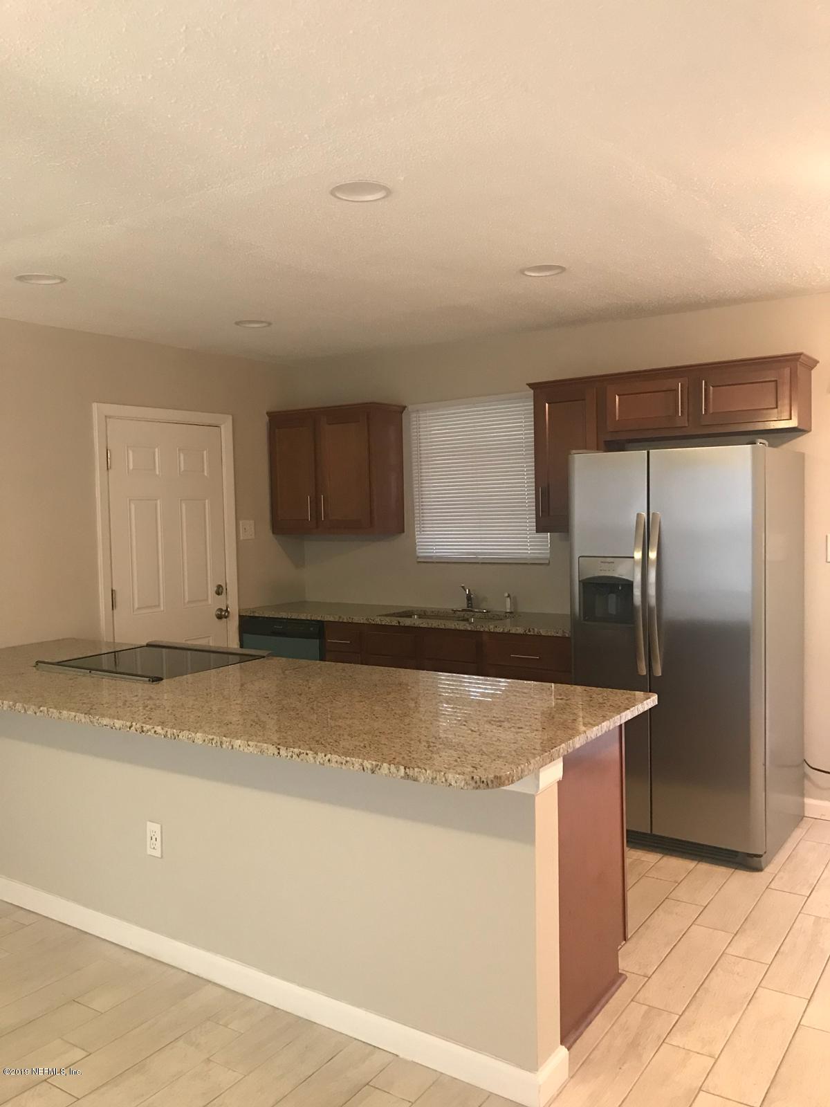 4705 Ruckner Road Jacksonville, FL 32207 - Photo 10 of 24 a kitchen with stainless steel appliances granite countertop a sink and a refrigerator