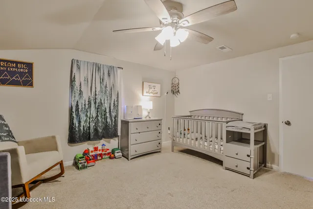 a bedroom with furniture and a chandelier fan