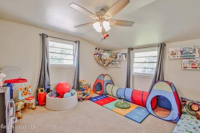 a bedroom with toys and a chandelier