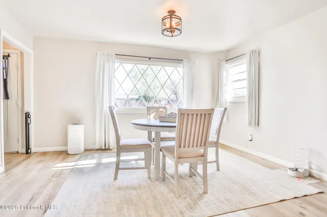a dining room with furniture and window