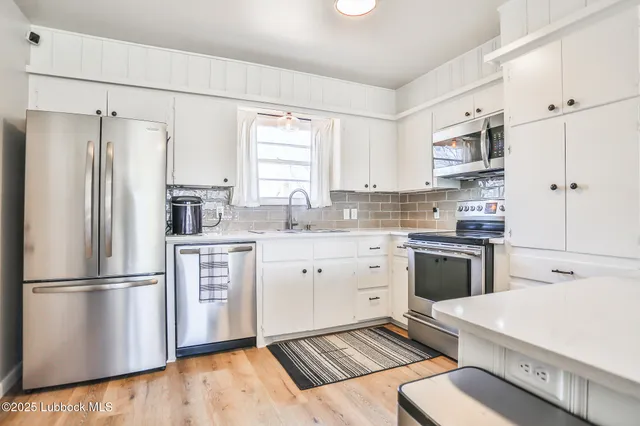 a kitchen with a refrigerator stove and sink
