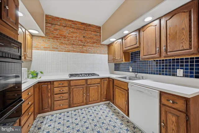 a kitchen with stainless steel appliances a sink stove and cabinets