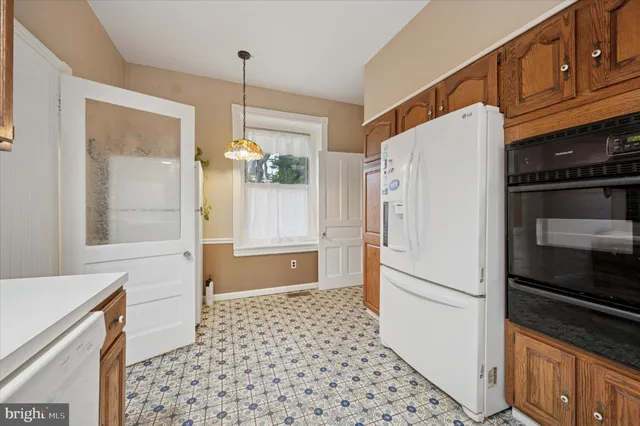 a white refrigerator freezer and a stove sitting inside of a kitchen