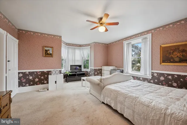 a spacious bedroom with a bed and window