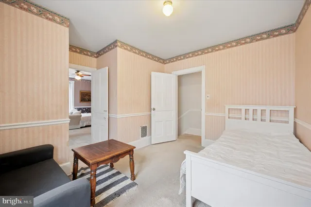 a bedroom with furniture and a rug