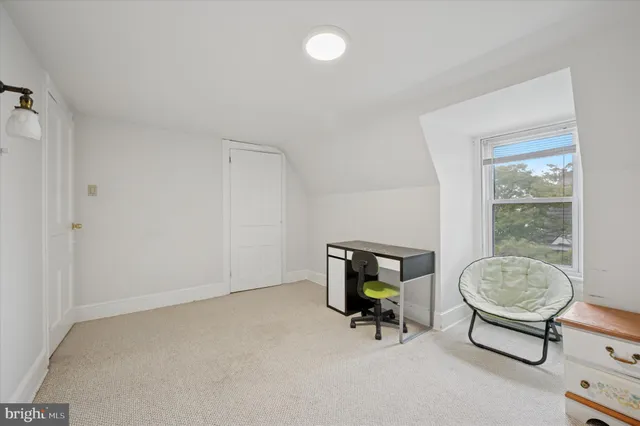 a bedroom with furniture and a lamp