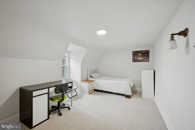 a bedroom with furniture and wooden floor