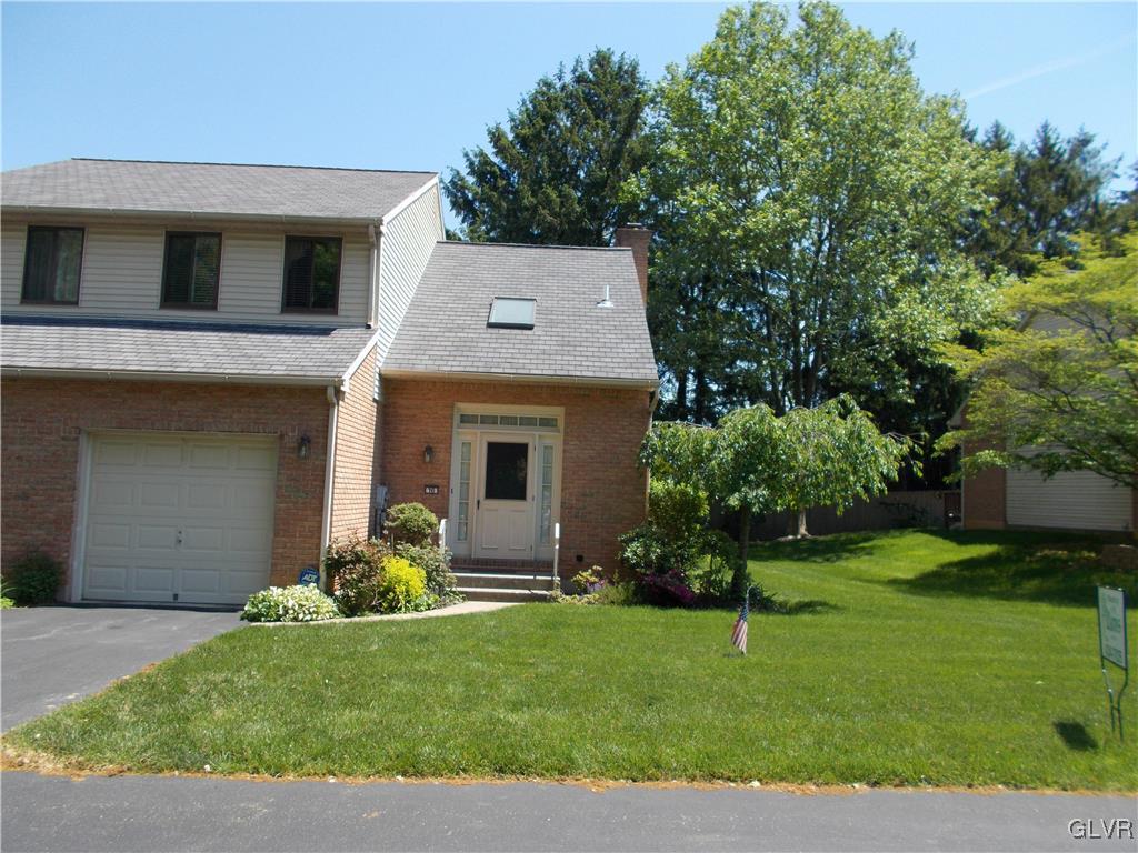 1201 Butztown Road, Unit 16 Bethlehem, PA 18017 - Photo 1 of 11 a front view of a house with a yard and garage