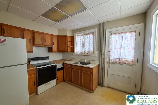 a kitchen with stainless steel appliances granite countertop a stove a refrigerator and a sink