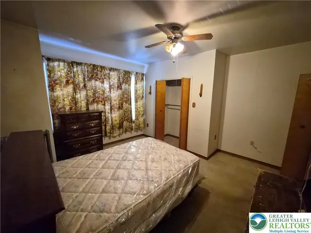 a bedroom with a bed and a dresser