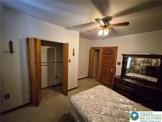 a bedroom with a bed and a television on desk