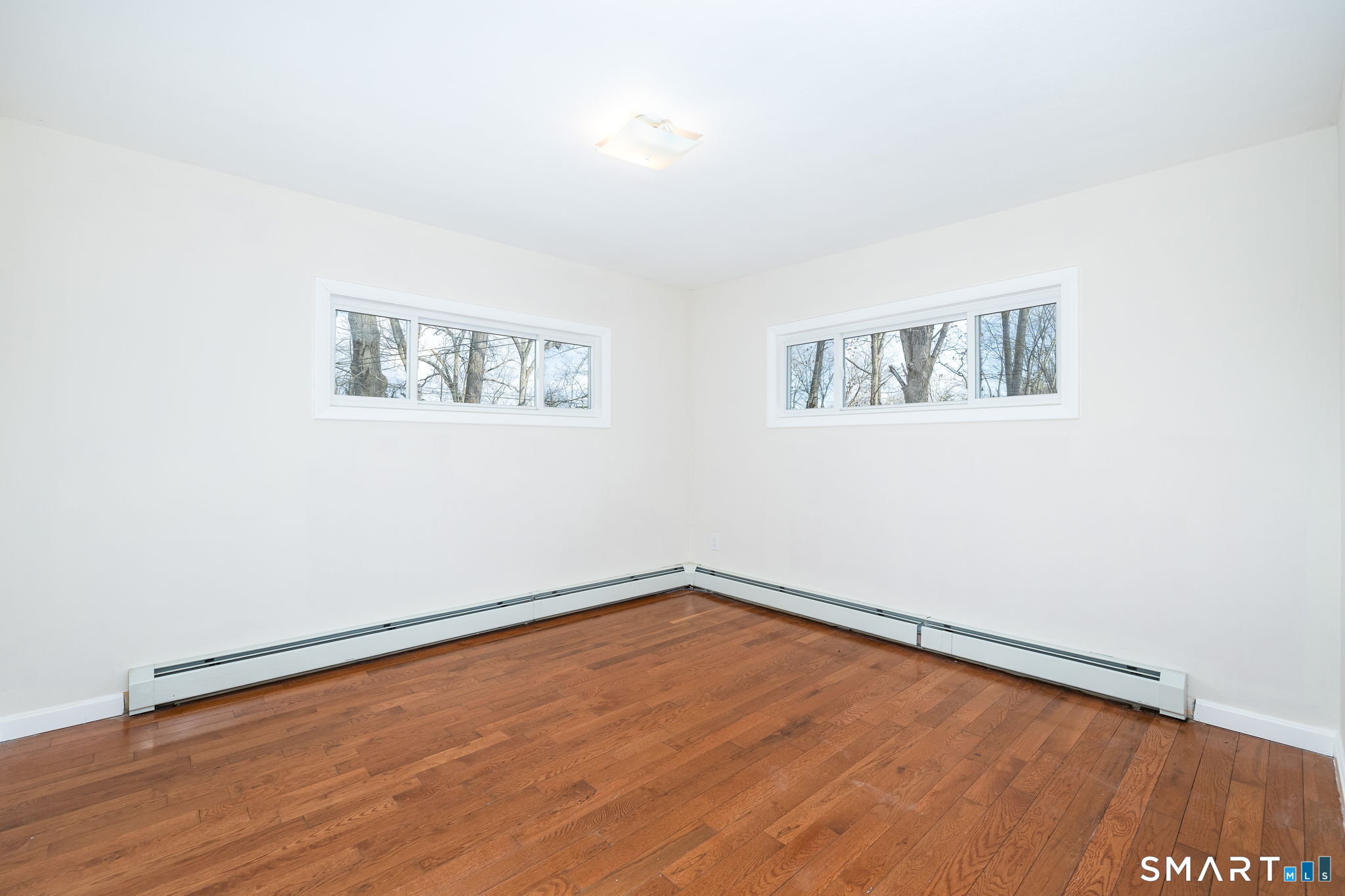 461 Pond Road Franklin, CT 06254 - Photo 18 of 35 an empty room with a painting and a lamp