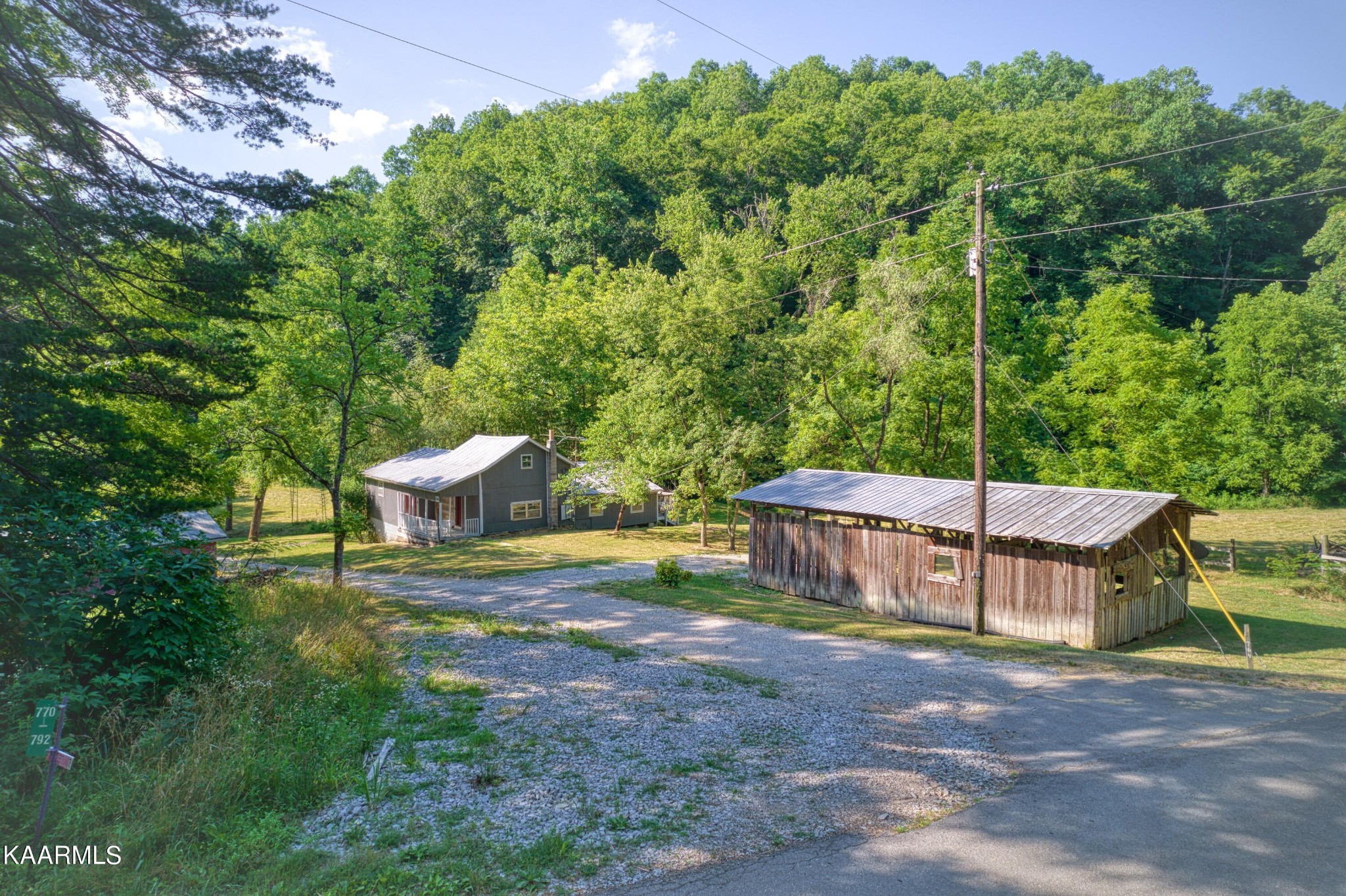 764 Mt Olive Road Andersonville, TN 37705 - Photo 19 of 37 a view of a chairs and table in the backyard