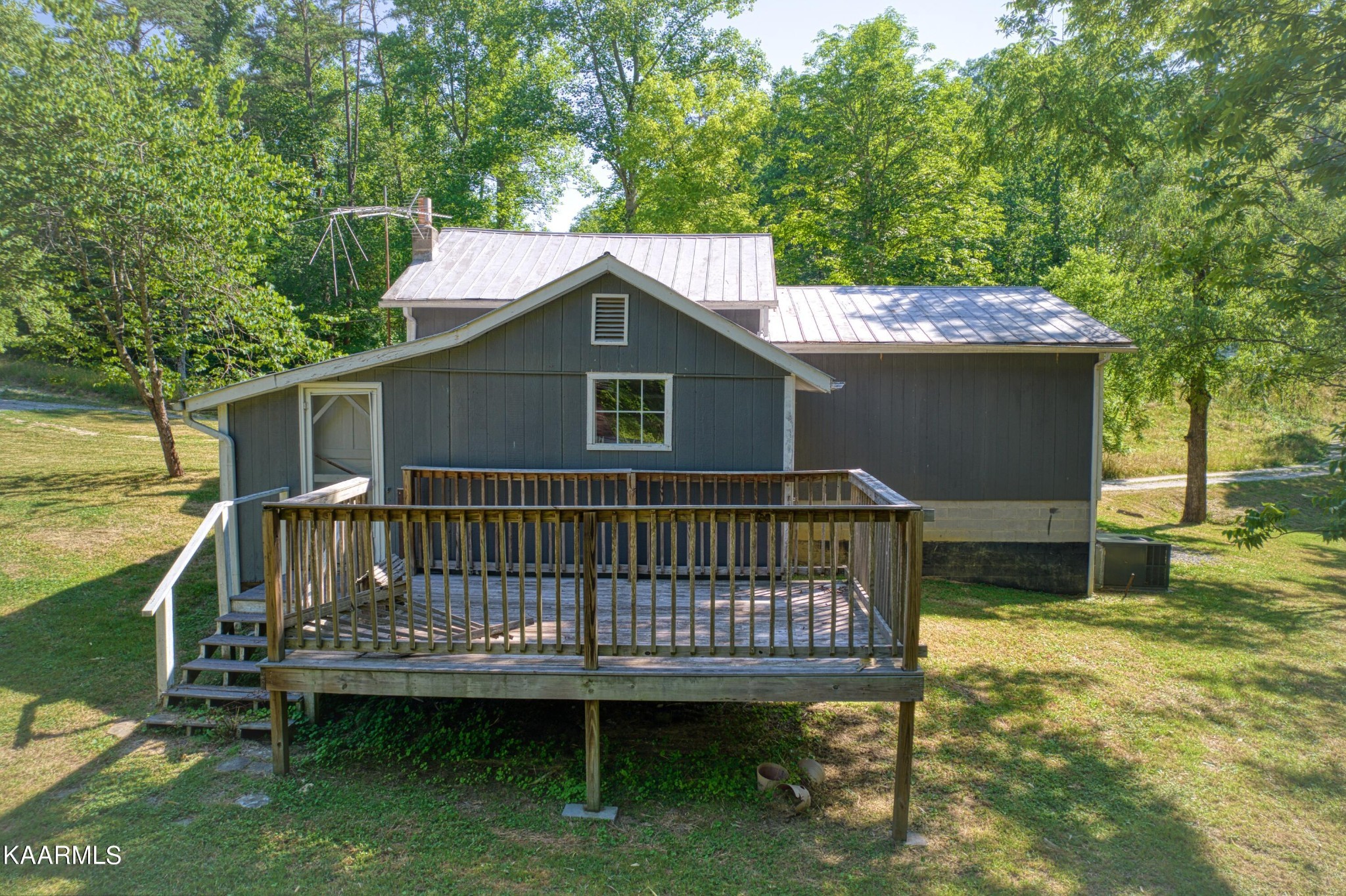 764 Mt Olive Road Andersonville, TN 37705 - Photo 3 of 37 a view of a deck with a table chairs and wooden fence