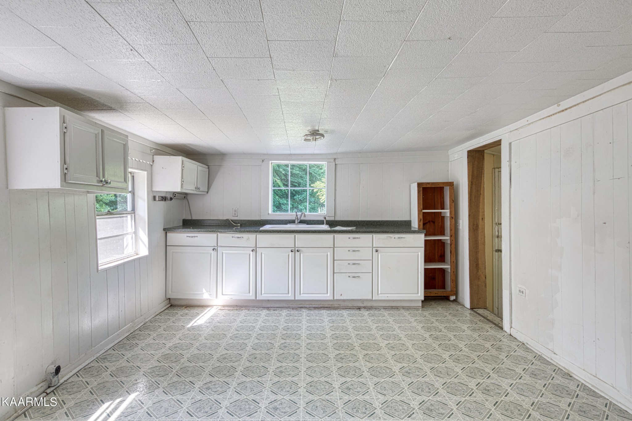 764 Mt Olive Road Andersonville, TN 37705 - Photo 10 of 37 a kitchen with a refrigerator and white cabinets