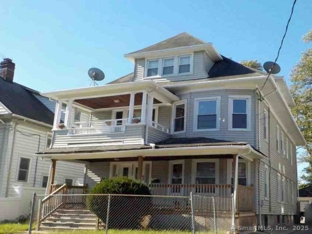 695-697 Laurel Avenue Bridgeport, CT 06604 - Photo 2 of 2 a front view of a house with balcony
