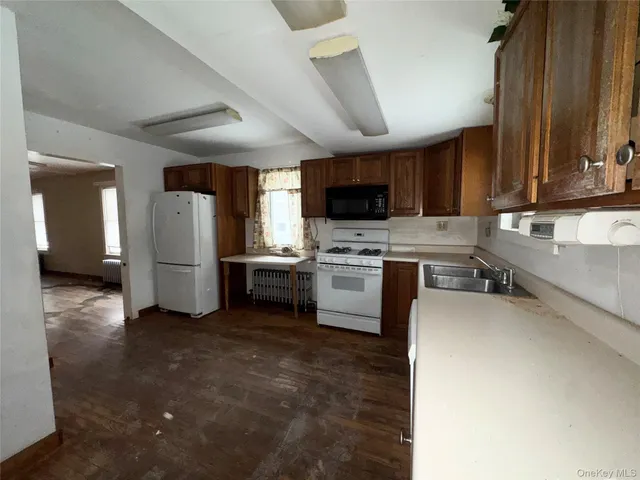 a kitchen with a refrigerator and a stove top oven