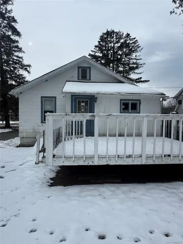 a view of a house with a wooden fence