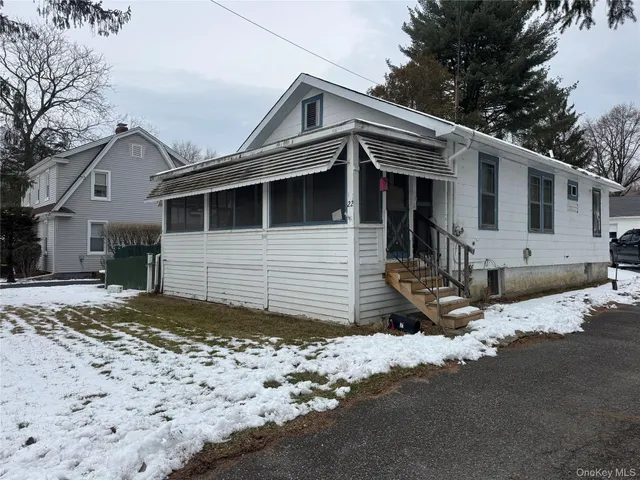 a view of a house with a snow on the road